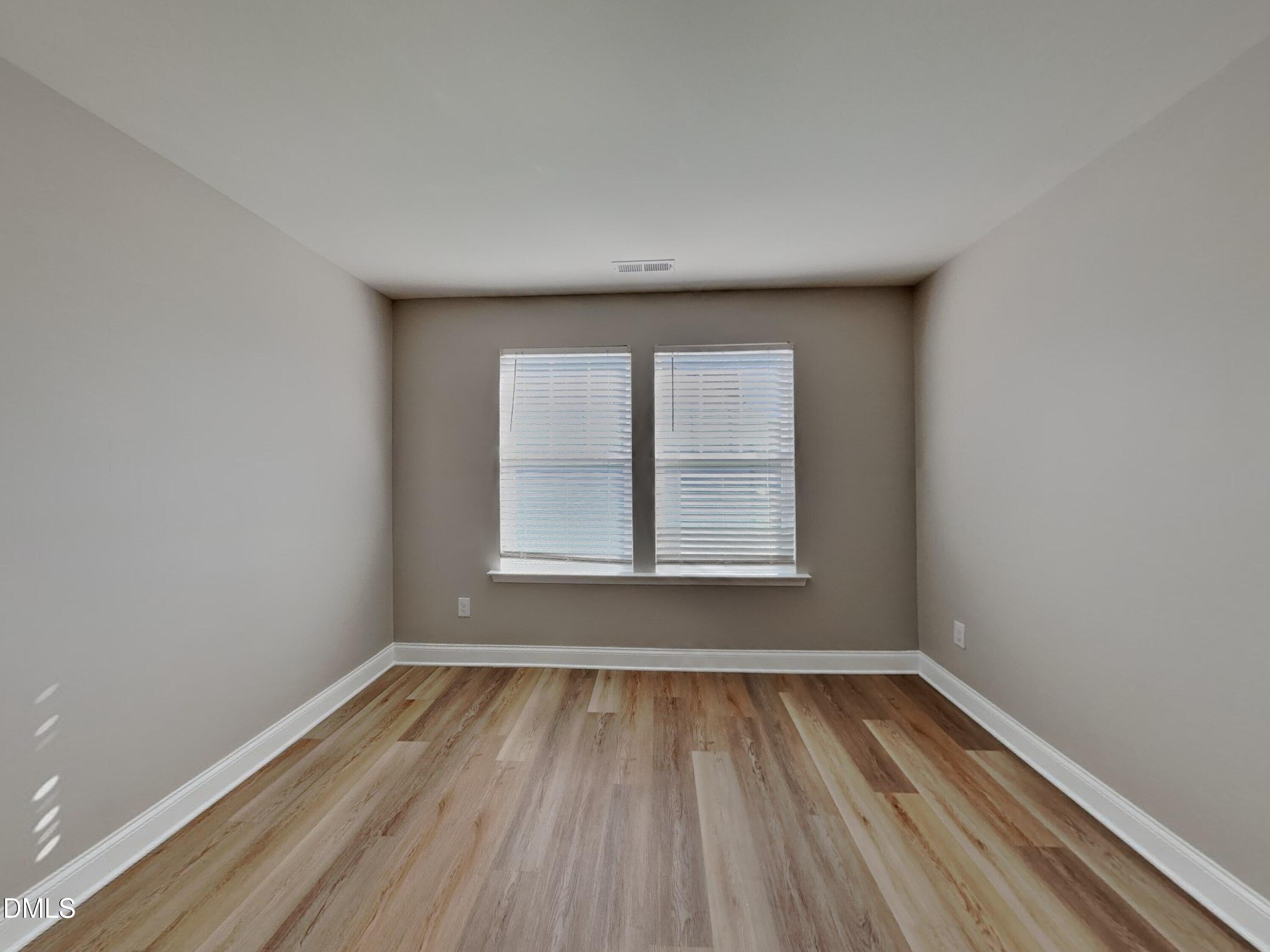 50 Gallery Park Drive Franklinton, NC 27525 - Photo 16 of 18 an empty room with wooden floor and windows