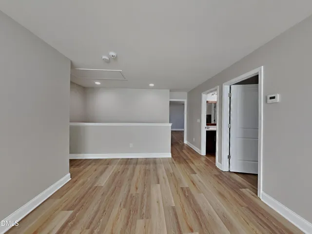 a view of a room with wooden floor and windows