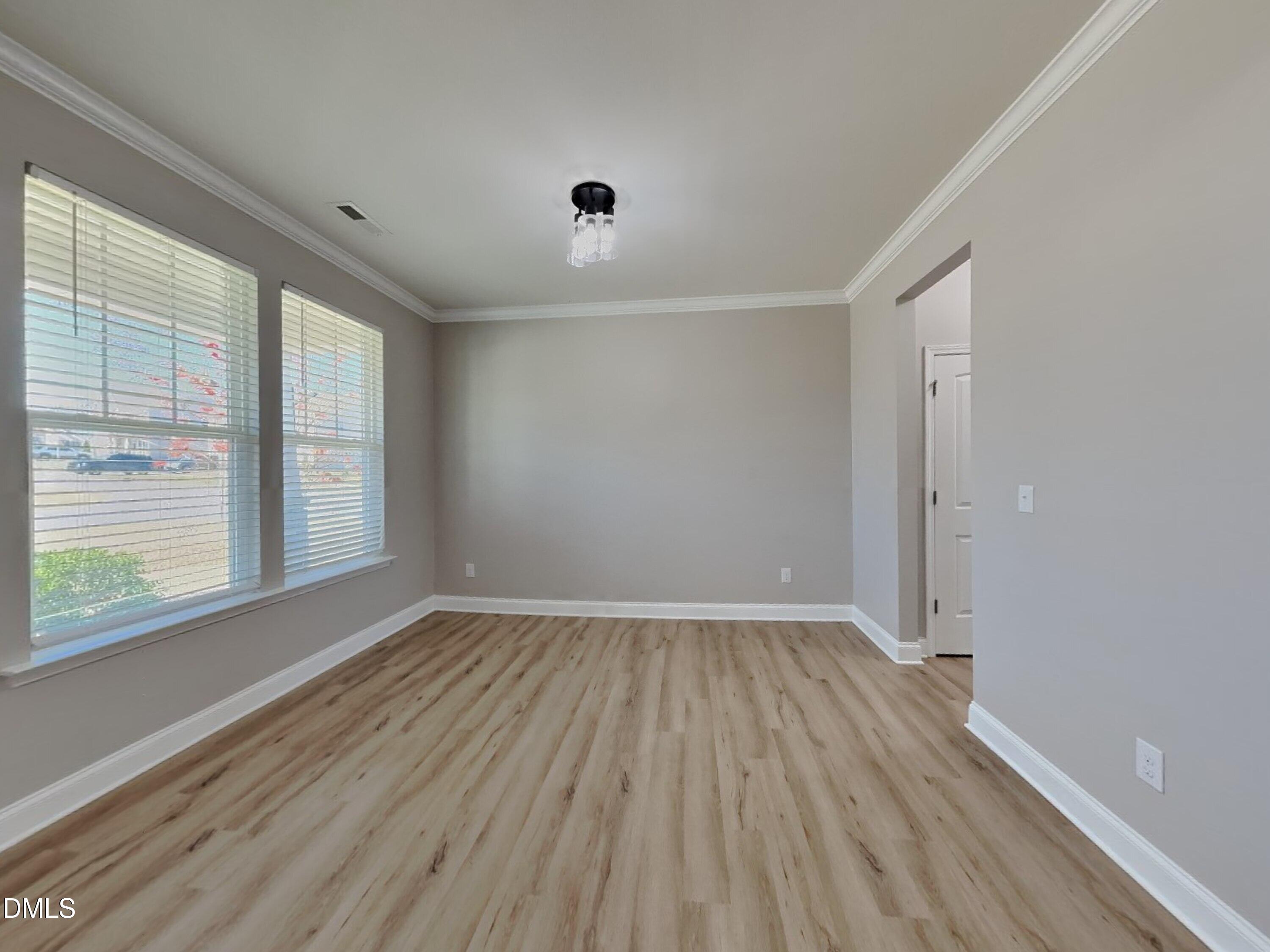 50 Gallery Park Drive Franklinton, NC 27525 - Photo 4 of 18 a view of an empty room with wooden floor and a window