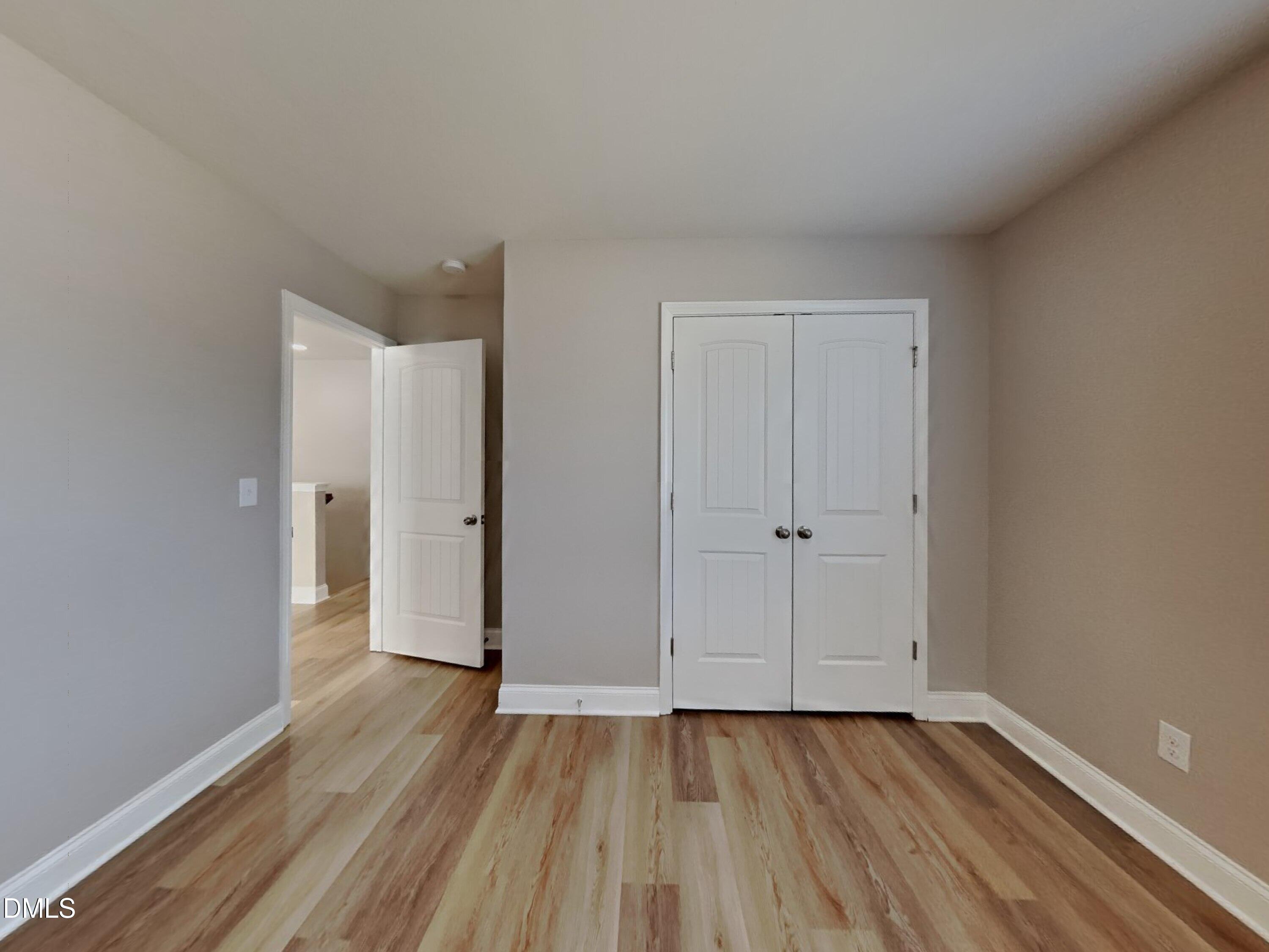 50 Gallery Park Drive Franklinton, NC 27525 - Photo 10 of 18 a view of an empty room with wooden floor and closet