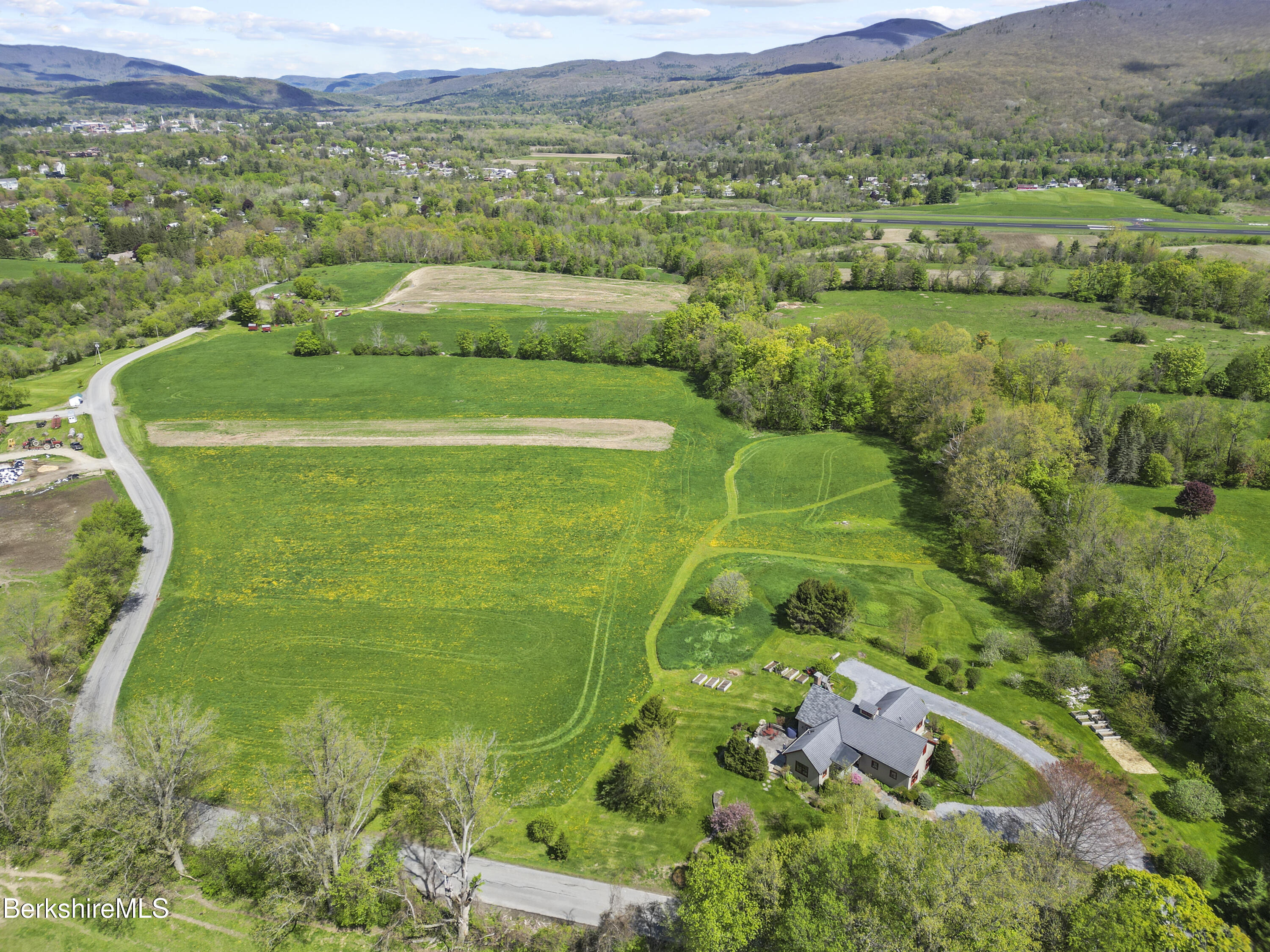 821 Pattison Road North Adams, MA 01247 - Photo 67 of 68 a view of a lush green field with a houses in the background