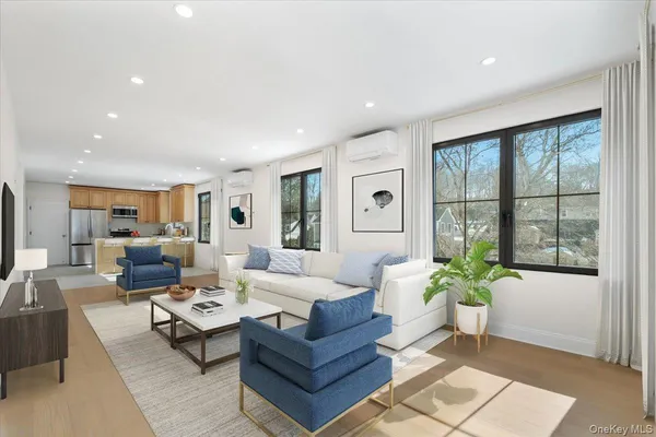a living room with furniture and a potted plant