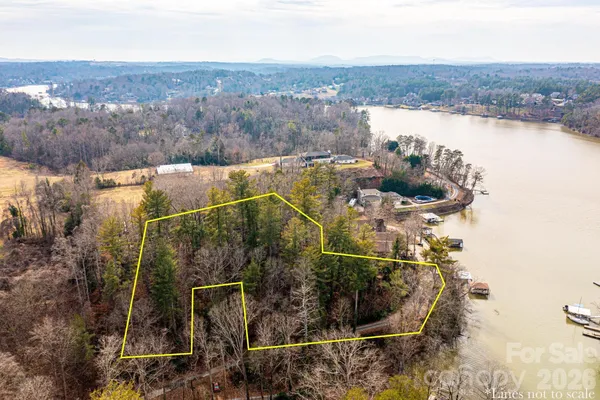 an aerial view of a house with a lake view