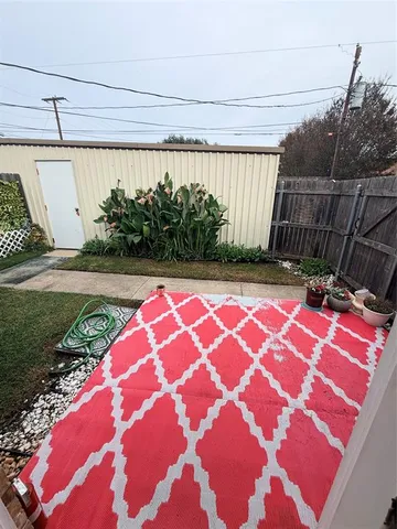 a backyard of a house with yard and outdoor seating