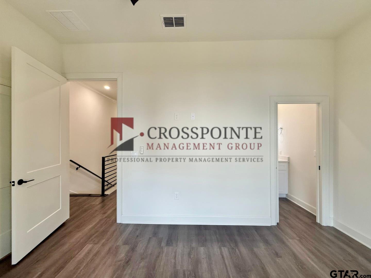 548 West Erwin Street Tyler, TX 75702 - Photo 24 of 27 a view of a hallway with wooden floor