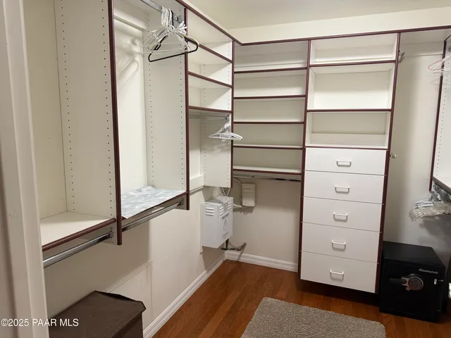 a view of walk in closet with empty racks