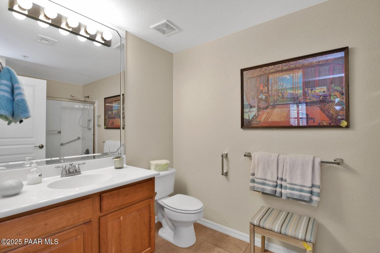 1716 Alpine Meadows Lane, Unit 1007 Prescott, AZ 86303 - Photo 13 of 21 a bathroom with a toilet a sink and mirror