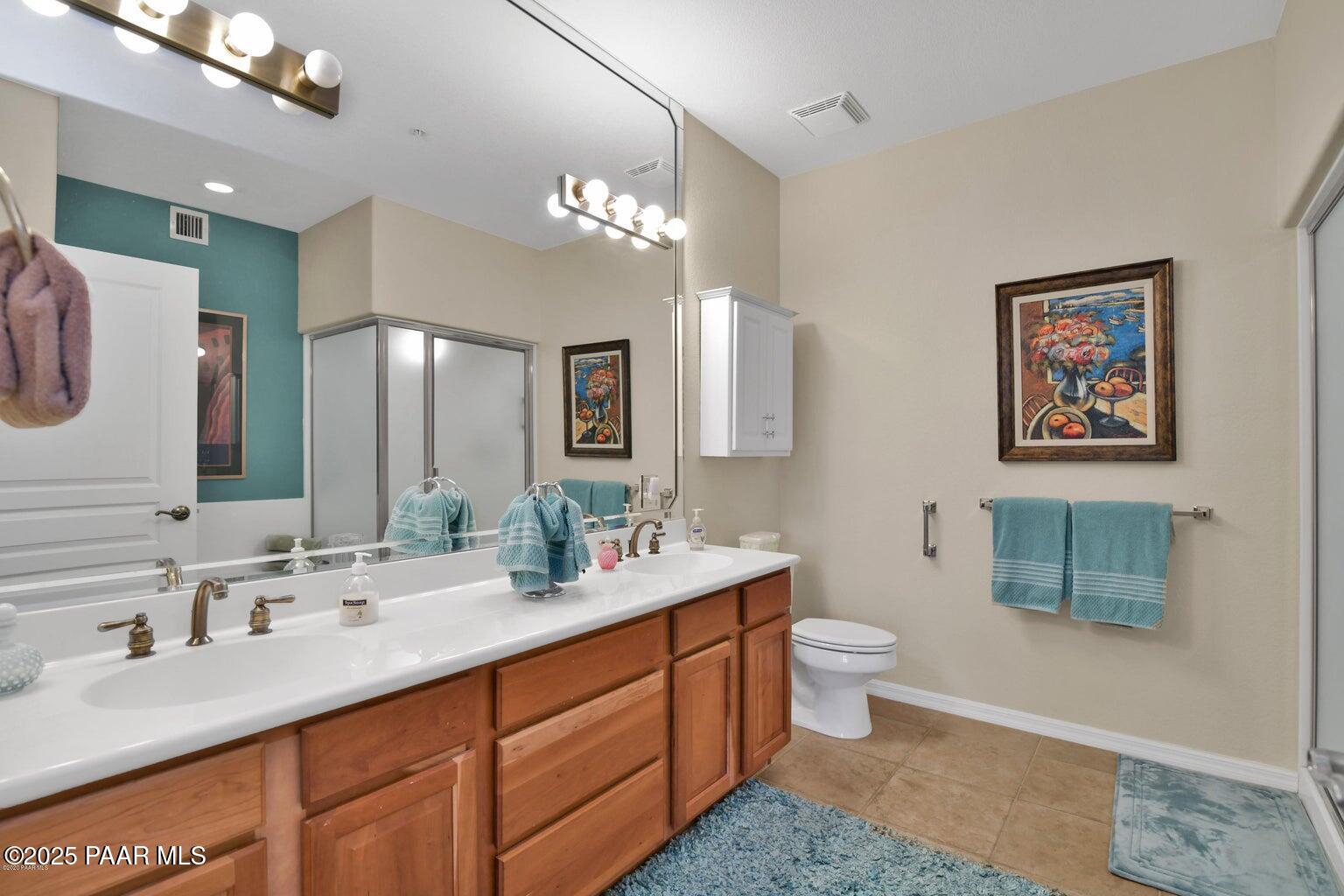 1716 Alpine Meadows Lane, Unit 1007 Prescott, AZ 86303 - Photo 14 of 21 a bathroom with a sink double vanity granite and a toilet