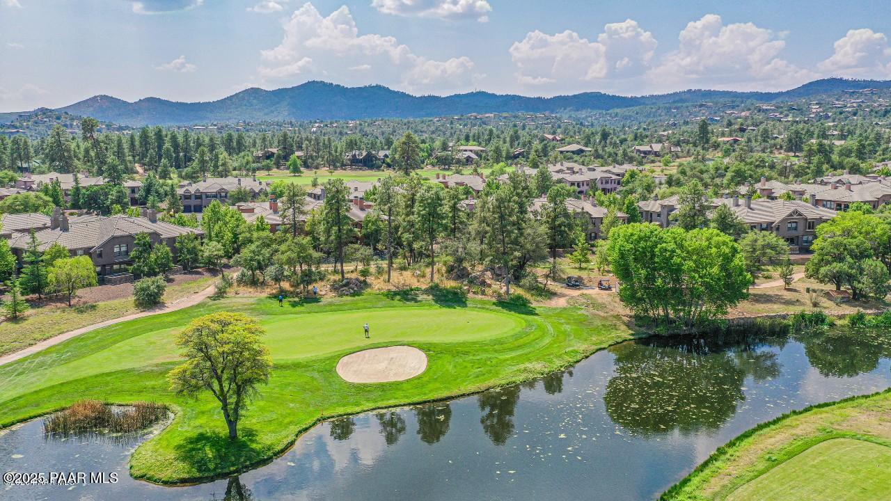 1716 Alpine Meadows Lane, Unit 1007 Prescott, AZ 86303 - Photo 18 of 21 a view of a table and chairs in the garden