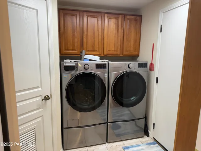 a view of a hallway with washer and dryer