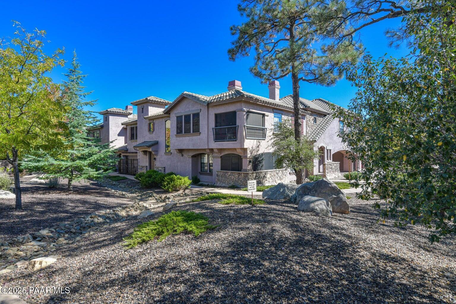 1716 Alpine Meadows Lane, Unit 1007 Prescott, AZ 86303 - Photo 2 of 21 a front view of a house with a yard