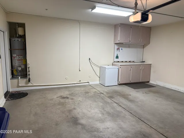 a kitchen with stainless steel appliances granite countertop a stove a sink and a refrigerator with cabinets