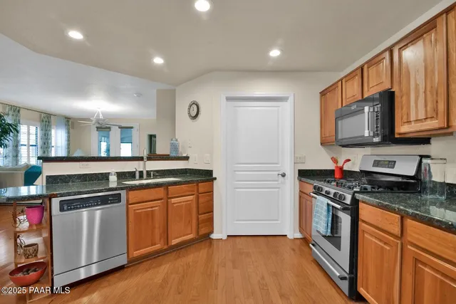 a kitchen with stainless steel appliances granite countertop a stove and a sink