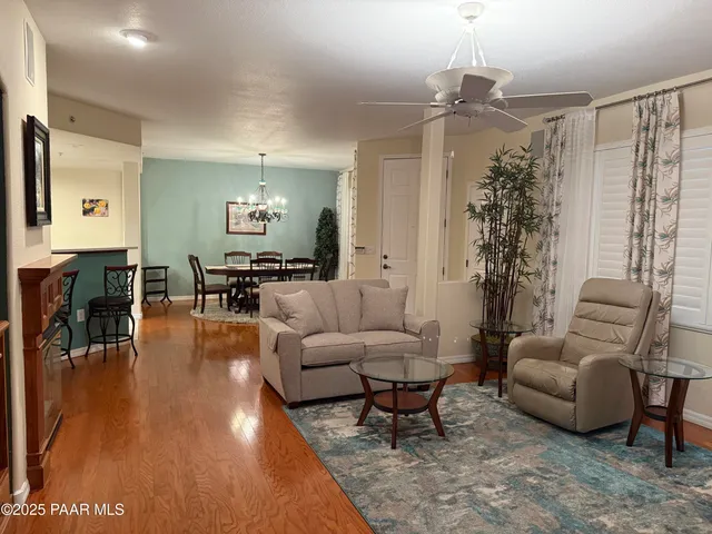 a living room with furniture and a chandelier