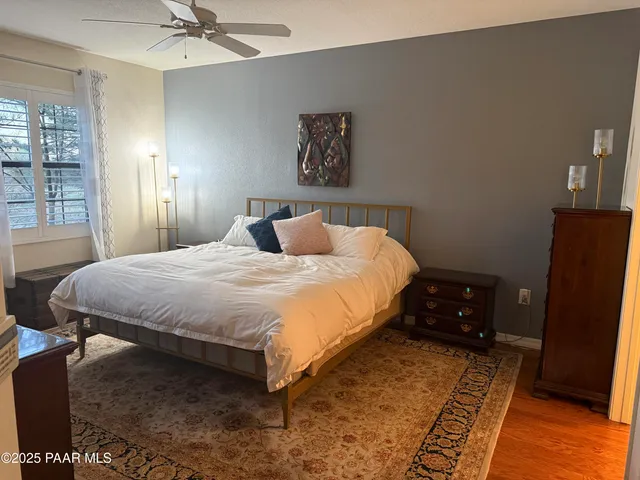 a bedroom with a bed and large mirror