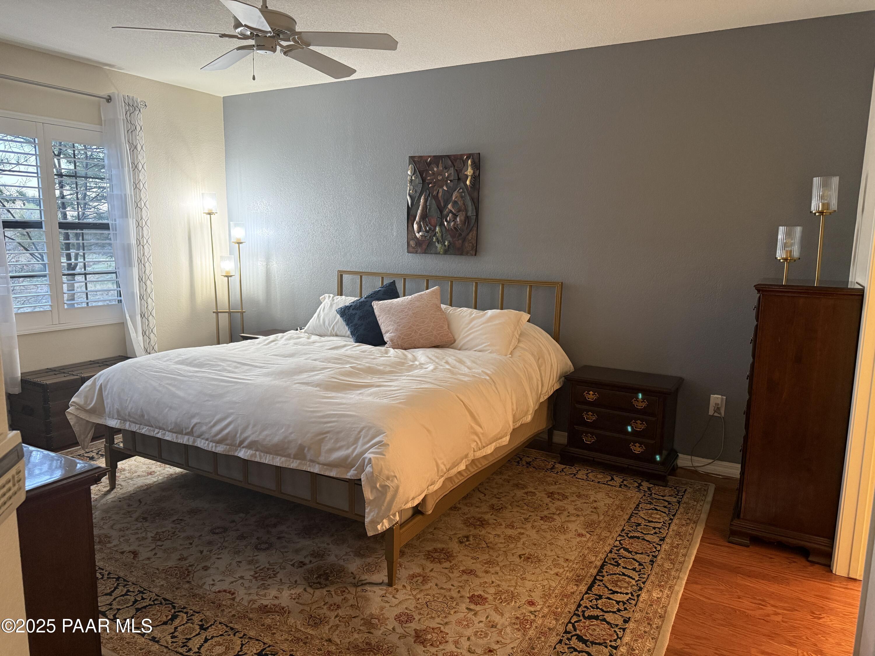 1716 Alpine Meadows Lane, Unit 1007 Prescott, AZ 86303 - Photo 10 of 21 a bedroom with a bed and large mirror