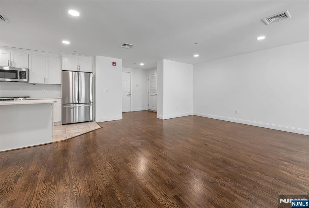 30 Jefferson Avenue, Unit C Westwood, NJ 07675 - Photo 3 of 9 a view of kitchen with wooden floor and refrigerator