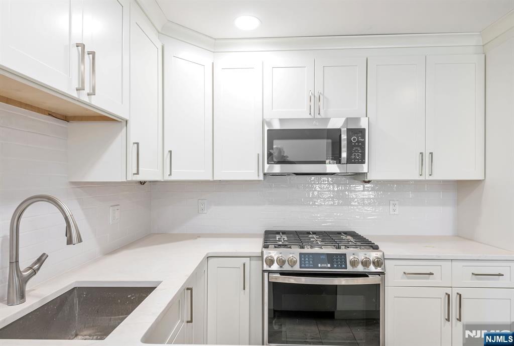 30 Jefferson Avenue, Unit C Westwood, NJ 07675 - Photo 5 of 9 a kitchen with granite countertop a stove and a sink