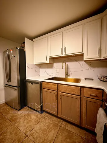 a kitchen with stainless steel appliances granite countertop a refrigerator sink and cabinets