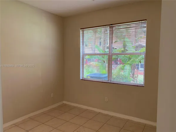 an empty room with wooden floor and a window