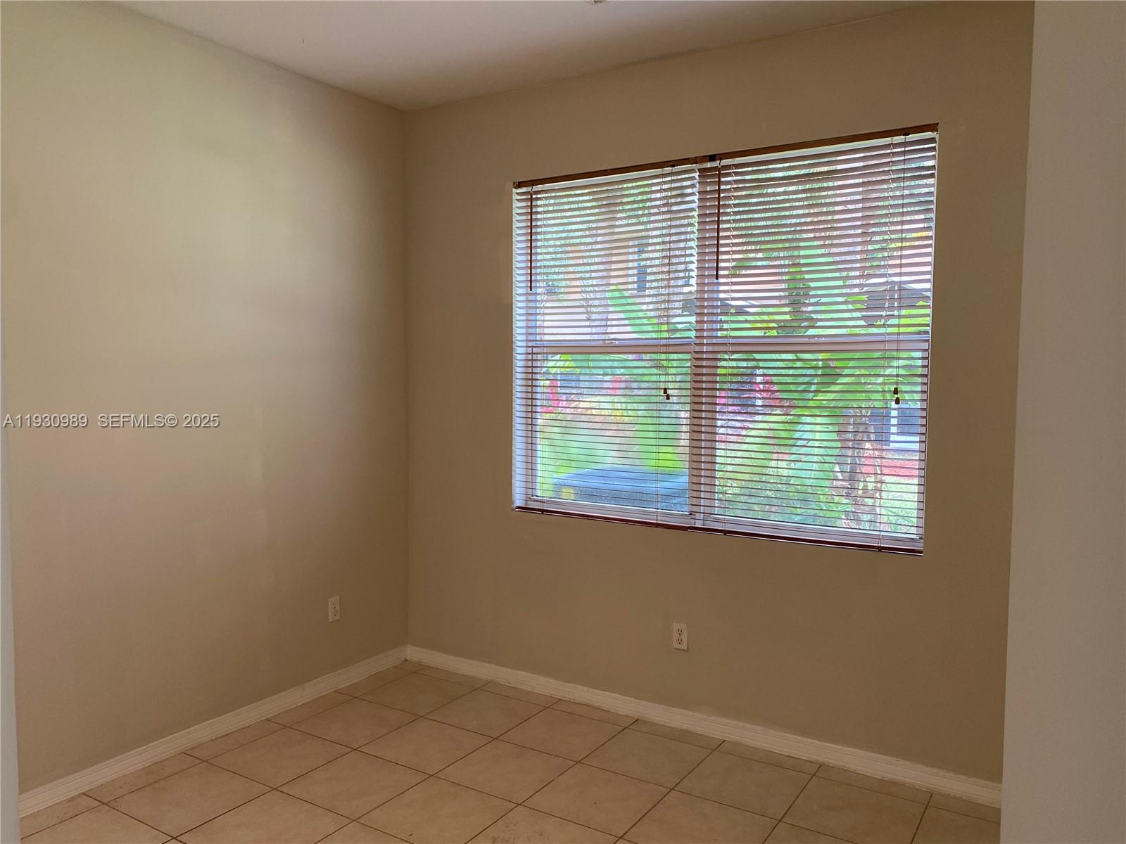 112 Wakulla Springs Way, Unit 112 Royal Palm Beach, FL 33411 - Photo 11 of 20 a view of an empty room with a window