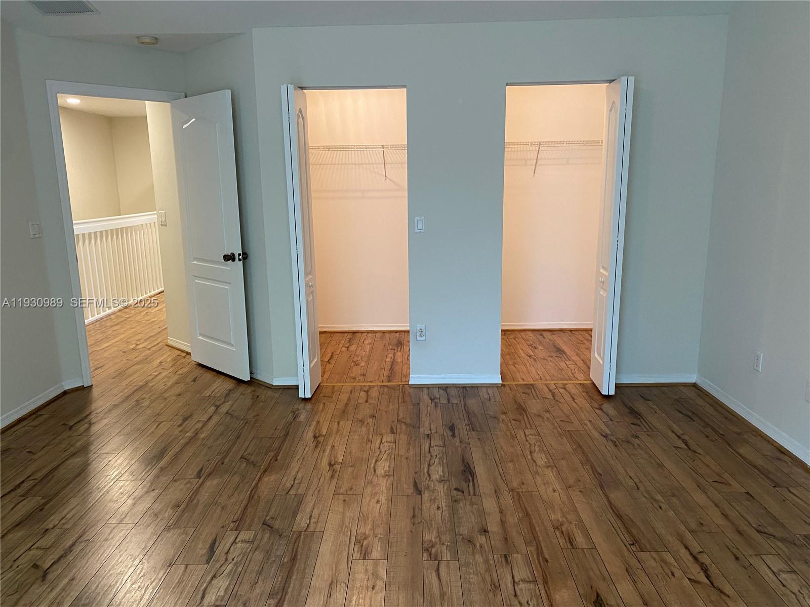 112 Wakulla Springs Way, Unit 112 Royal Palm Beach, FL 33411 - Photo 13 of 20 an empty room with wooden floor and a window