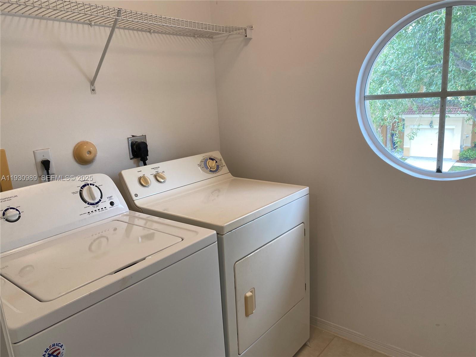 112 Wakulla Springs Way, Unit 112 Royal Palm Beach, FL 33411 - Photo 17 of 20 a utility room with dryer and washer