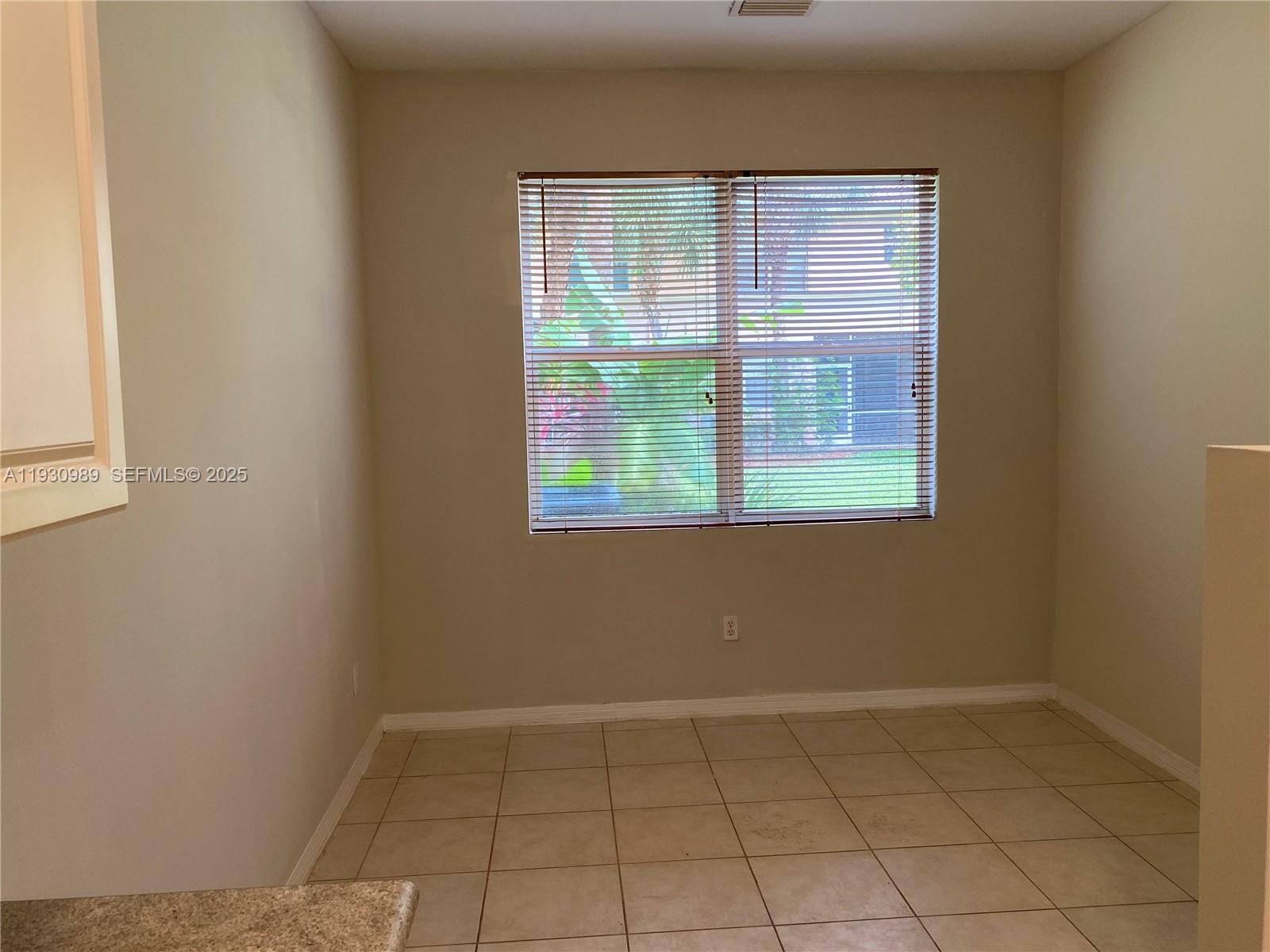 112 Wakulla Springs Way, Unit 112 Royal Palm Beach, FL 33411 - Photo 18 of 20 an empty room with a window