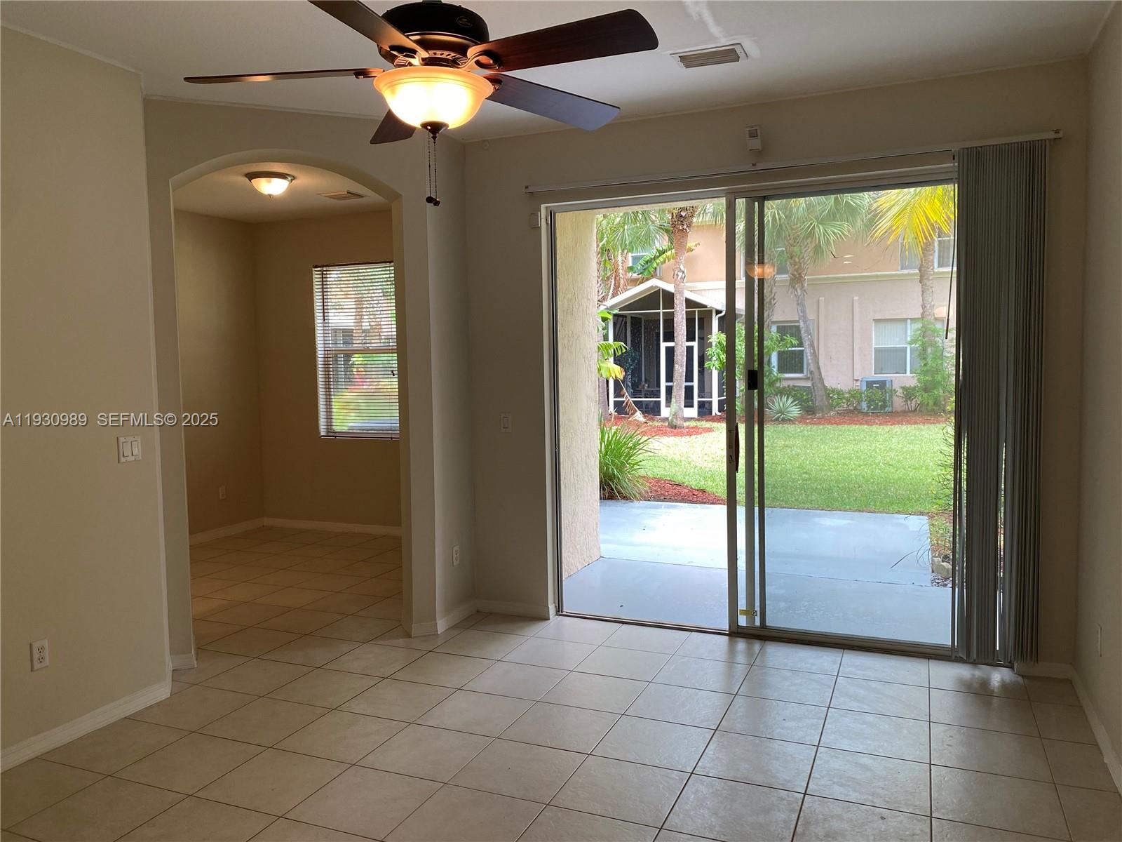 112 Wakulla Springs Way, Unit 112 Royal Palm Beach, FL 33411 - Photo 5 of 20 wooden floor in an empty room with a window