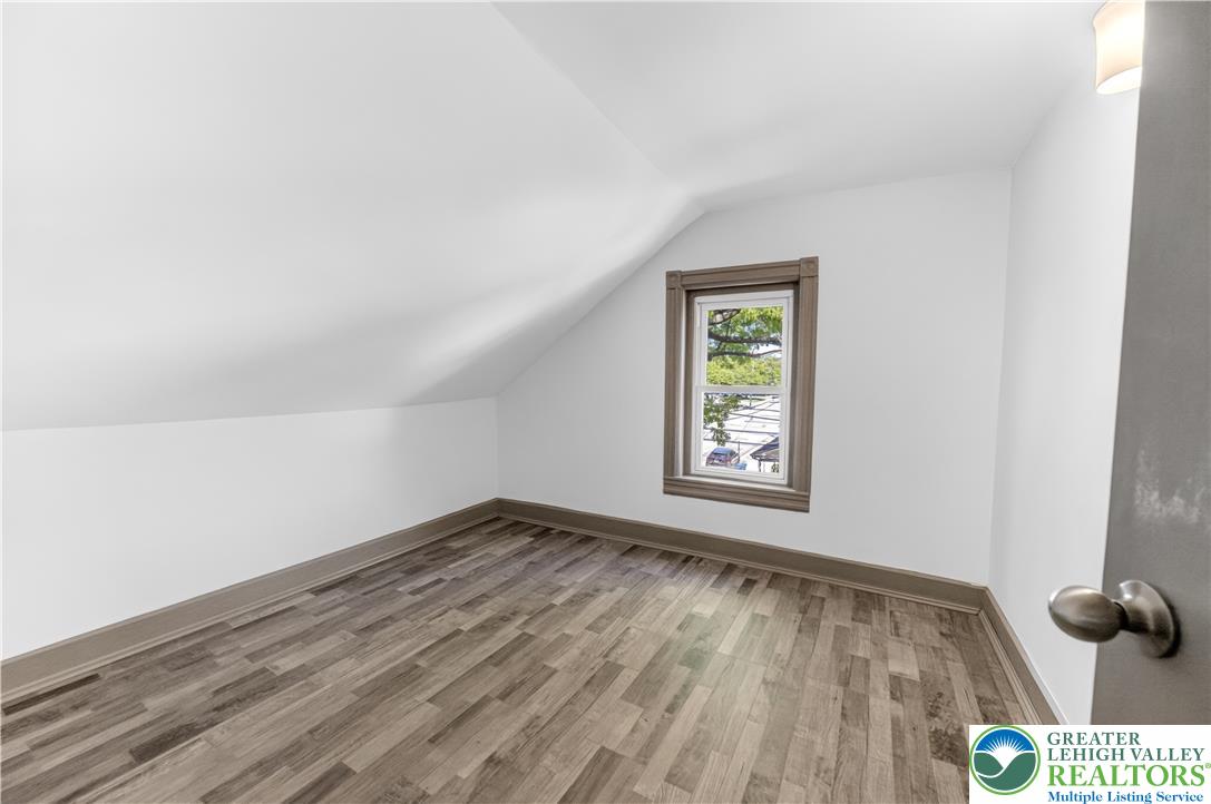 1128 Maple Street Bethlehem, PA 18018 - Photo 11 of 34 A versatile attic room with sloped ceilings and durable flooring awaits your personal touch.