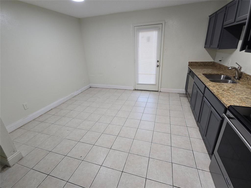 10500 Lake June Road, Unit I03 Dallas, TX 75217 - Photo 4 of 11 a kitchen with a sink and cabinets