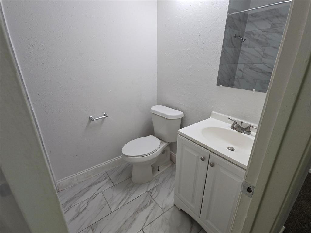 10500 Lake June Road, Unit I03 Dallas, TX 75217 - Photo 5 of 11 a white toilet sitting next to a white sink