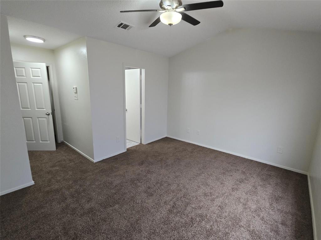 10500 Lake June Road, Unit I03 Dallas, TX 75217 - Photo 6 of 11 an empty room with fan walk in closet with window