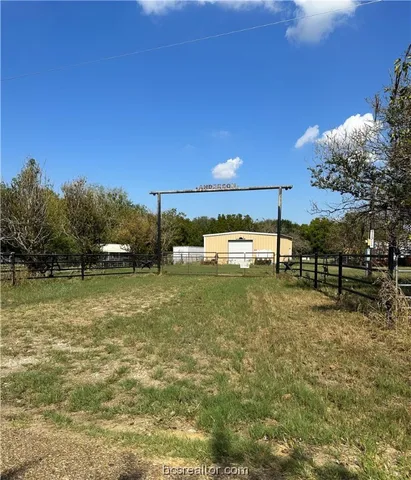 a view of a field with sitting area