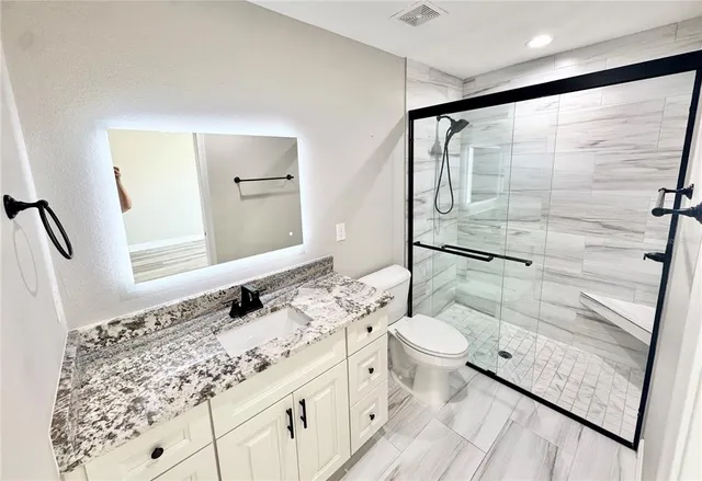 a bathroom with a sink toilet and shower