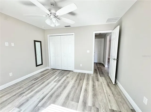a view of a livingroom with a hardwood floor and a ceiling fan