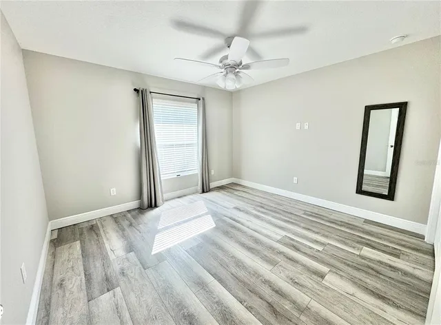 a view of a room with wooden floor and closet