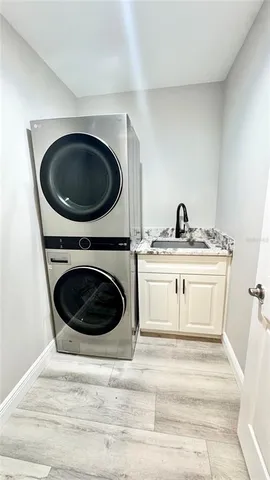 a utility room with a sink washer and dryer