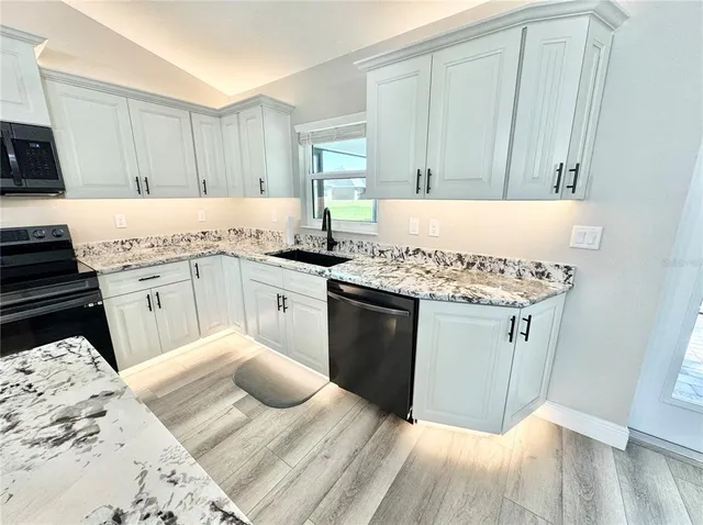 a kitchen with a sink stove and cabinets