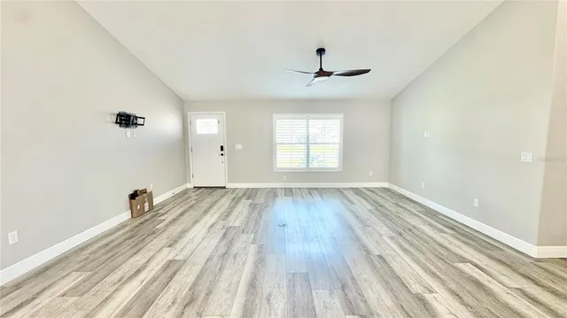 wooden floor in an empty room with a window