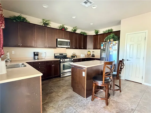 a kitchen with a sink a counter and cabinets