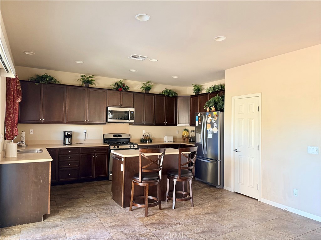 19422 Royal Oaks Road Apple Valley, CA 92308 - Photo 12 of 30 a kitchen with lots of counter top space and appliances