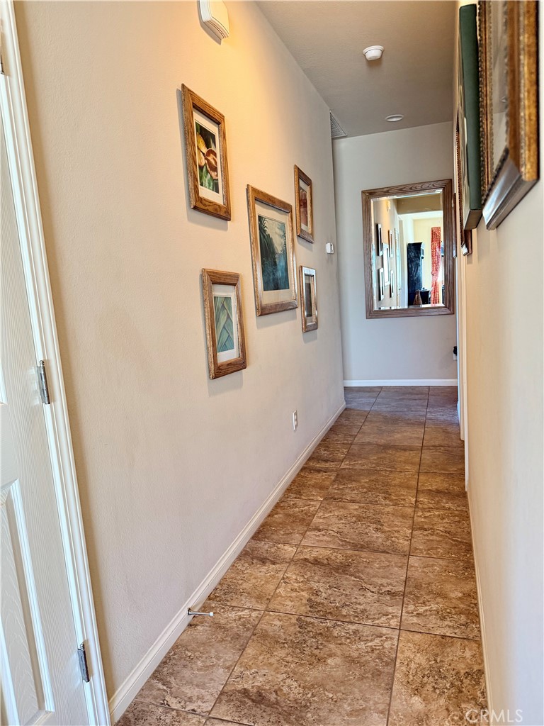 19422 Royal Oaks Road Apple Valley, CA 92308 - Photo 14 of 30 a view of a hallway with wooden floor and a living room