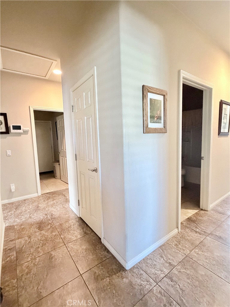 19422 Royal Oaks Road Apple Valley, CA 92308 - Photo 15 of 30 a view of a hallway with closet and bathroom