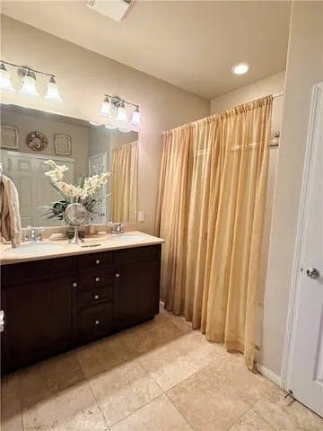 a bathroom with a double vanity sink and a mirror
