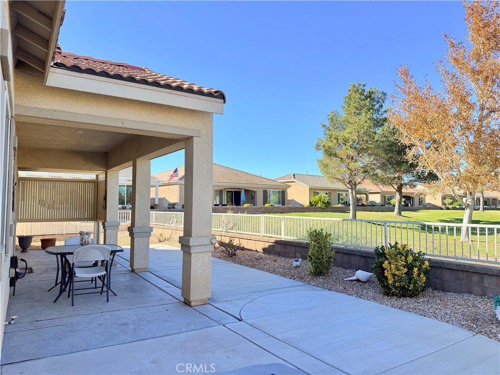 19422 Royal Oaks Road Apple Valley, CA 92308 - Photo 23 of 30 a view of a house with wooden floor and outdoor seating