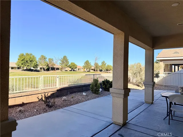 a view of a floor and a table in the patio