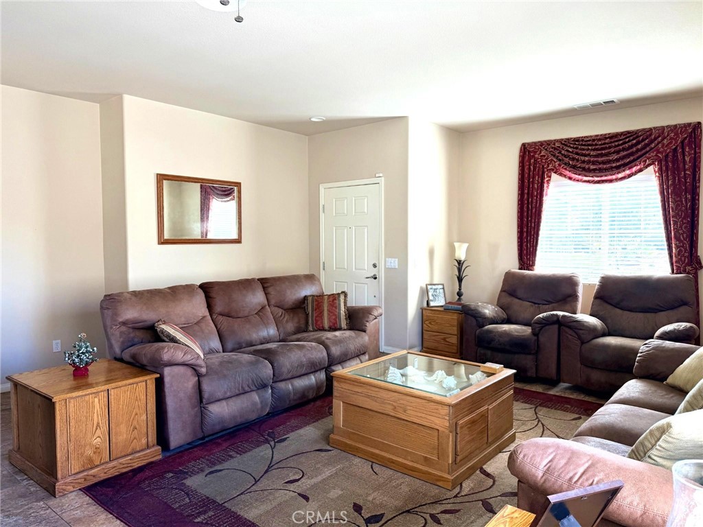 19422 Royal Oaks Road Apple Valley, CA 92308 - Photo 6 of 30 a living room with furniture and a window