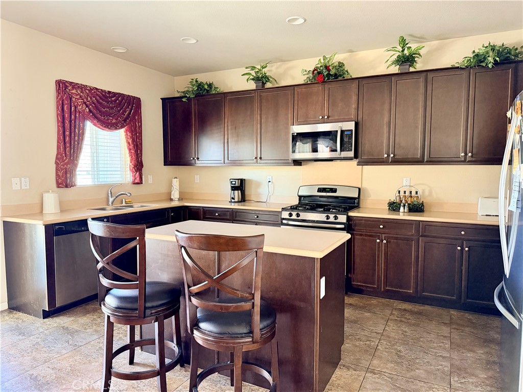 19422 Royal Oaks Road Apple Valley, CA 92308 - Photo 9 of 30 a kitchen with a sink cabinets and window