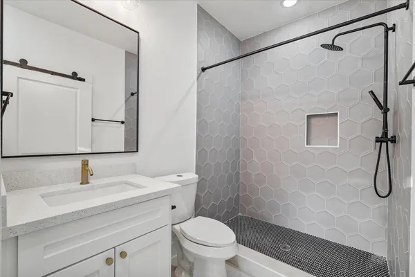 a bathroom with a sink shower and a toilet